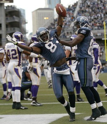 SEATTLE - AUGUST 25:  Wide receiver Nate Burleson #81 of the Seattle Seahawks celebrates an apparent touchdown with Deion Branch #83 during a preseason game against the Minnesota Vikings at Qwest Field August 25, 2007 in Seattle, Washington. Burleson was 