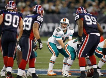 TORONTO, ON - DECEMBER 07:  Chad Pennington #10 of the Miami Dolphins calls signals as Chris Kelsay #90, Kawika Mitchell #59 and Marcus Stroud #99 of the Buffalo Bills line up on December 7, 2008  at Rogers Centre in Toronto, Ontario, Canada. The Dolphins