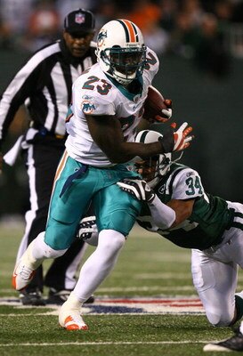 EAST RUTHERFORD, NJ - DECEMBER 28:  Ronnie Brown #23 of the Miami Dolphins in runs the ball as Dwight Lowery #34 of the New York Jets defends during their game on December 28, 2008 at Giants Stadium in East Rutherford, New Jersey.  (Photo by Al Bello/Gett