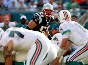 MIAMI - NOVEMBER 23:  Linebacker Mike Vrabel #50 of the New England Patriots looks in as quarterback Chad Pennington #10 of the Miami Dolphins prepares to take the snap at Dolphin Stadium on November 23, 2008 in Miami, Florida. The Patriots defeated the D