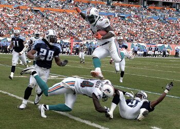 MIAMI - DECEMBER 24:  Running back Ricky Williams #34 of the Miami Dolphins goes airborne for a first down against the Tennessee Titans in the second quarter on December 24, 2005 at Miami Dolphins Stadium in Miami, Florida.  (Photo by Eliot J. Schechter/G
