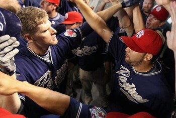 PHOENIX - MAY 25:  Chase Headley #7 (L) of the San Diego Padres celebrates with teammates in the dugout after hitting a 2 run home run against the Arizona Diamondbacks during the tenth inning of the major league baseball game at Chase Field on May 25, 200