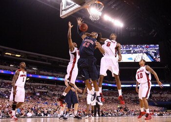 INDIANAPOLIS - MARCH 27:  Jordan Hill #43 of the Arizona Wildcats reaches for a rebound against Terrence Jennings #23 and Earl Clark #5 of the Louisville Cardinals  during the third round of the NCAA Division I Men's Basketball Tournament at the Lucas Oil