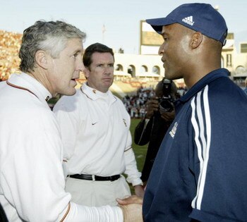 LOS ANGELES - NOVEMBER 22:  Head coach Pete Carroll of UCLA and head coach Karl Dorrell of USC shake hands after the game at the Los Angeles Memorial Coliseum on November 22, 2003 in Los Angeles, California.  USC defeated UCLA 47-22. (Photo by Todd Warsha