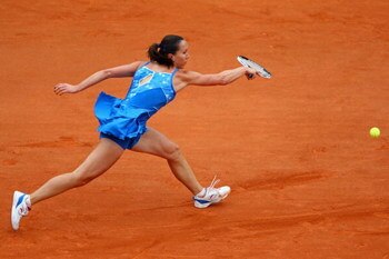 PARIS - MAY 26:  Jelena Jankovic of Serbia stretches to hit a backhand during her Women's Singles First Round match against Petra Cetkovska of the Czech Republic on day three of the French Open at Roland Garros on May 26, 2009 in Paris, France.  (Photo by