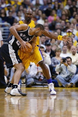 LOS ANGELES - MAY 11:  Tim Duncan #21 of the San Antonio Spurs is covered by Karl Malone #11 of the Los Angeles Lakers in Game four of the Western Conference Semifinals during the 2004 NBA Playoffs at Staples Center on May 11, 2004 in Los Angeles, Califor