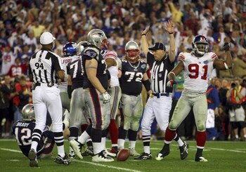 GLENDALE, AZ - FEBRUARY 03:  Quarterback Tom Brady #12 of the New England Patriots lies on his back after being sacked by defensive end Justin Tuck #91 of the New York Giants in the third quarter during Super Bowl XLII on February 3, 2008 at the Universit