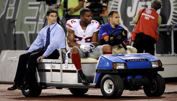 EAST RUTHERFORD, NJ - AUGUST 23: Osi Umenyiora #92 of the New York Giants leaves the game due to an injury during a preseason NFL game against the New York Jets at Giants Stadium in the Meadowlands August 23, 2008 in East Rutherford, New Jersey. (Photo