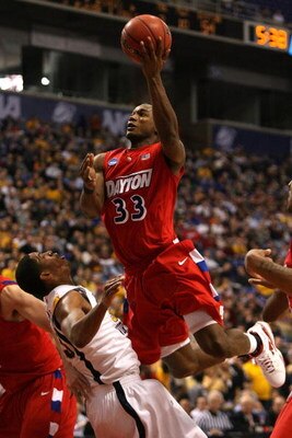 MINNEAPOLIS - MARCH 20:  Chris Wright #33 of the Dayton Flyers drives for a shot attempt against Wellington Smith #35 of the West Virginia Moutaineers during the first round of the NCAA Division I Men's Basketball Tournament at the Hubert H. Humphrey Metr