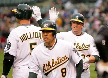 OAKLAND, CA - MAY 23:  Jack Cust #32 of the Oakland Athletics is congratulated by Matt Holliday after Cust hit a two-run home run that scored Kurt Suzuki #8 in the first inning of their game against the Arizona Diamondbacks at the Oakland Coliseum on May 