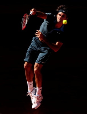 MADRID, SPAIN - MAY 17:  Roger Federer of Switzerland serves the ball to Rafael Nadal of Spain during the final of the Madrid Open tennis tournament at the Caja Magica on May 17, 2009 in Madrid, Spain. Federer won the match in two sets, 6-4 and 6-4.  (Pho