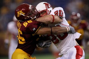 MINNEAPOLIS, MN - SEPTEMBER 08:  Tom Crabtree #80 of the Miami of Ohio Redhawks makes a reception and is tackled by Steve Davis #56 of the Minnesota Golden Gophers on September 8, 2007 at the Metrodome in Minneapolis, Minnesota.  (Photo by Doug Pensinger/