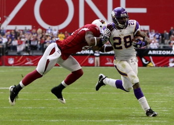 GLENDALE, AZ - DECEMBER 14:  Running back Adrian Peterson #28 of the Minnesota Vikings is pushed out of bounds by Antrel Rolle #21 of the Arizona Cardinals  after a 25 yard gain during the first quarter at the University of Phoenix Stadium on December 14,