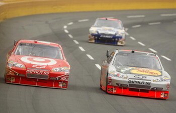 CONCORD, NC - MAY 25:  Juan Pablo Montoya, driver of the #42 Target Chevrolet, races Martin Truex Jr., driver of the #1 Bass Pro Shops/Tracker Boats Chevrolet, during the NASCAR Sprint Cup Series Coca-Cola 600 on May 25, 2009 at Lowe's Motor Speedway in C