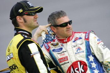 RICHMOND, VA - MAY 01:  Paul Menard (L), driver of the #98 Nibco/Menards Ford, talks with teammate Bobby Labonte (R), driver of the #96 Ask.com Ford, during qualifying for the NASCAR Sprint Cup Series Crown Royal Presents the Russ Friedman 400 at Richmond