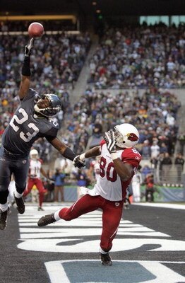SEATTLE - DECEMBER 9: Marcus Trufant #23 of the Seattle Seahawks leaps to block the pass to Bryant Johnson #80 of the Arizona Cardinals December 9, 2007 at Qwest Field in Seattle, Washington. The Seahawks defeated the Cardinals 42-21. (Photo by Otto Greul