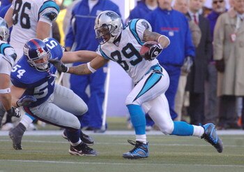 Steve Smith of the Carolina Panthers runs past Nick Greisen during the NFC Wild Card playoff game between the New York Giants and Carolina Panthers at Giants Stadium in East Rutherford, New Jersey on January 8, 2006.  (Photo by Al Messerschmidt/Getty Imag