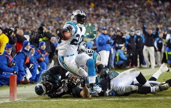 PHILADELPHIA - JANUARY 18:  Running back DeShaun Foster #20 of the Carolina Panthers scores a touchdown on a 1-yard run against the Philadelphia Eagles in the third quarter during the NFC Championship game on January 18, 2004 at Lincoln Financial Field in