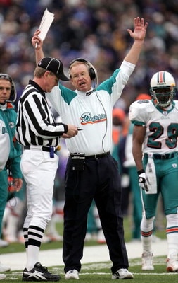 BALTIMORE - JANUARY 2:  Head coach Jim Bates of the Miami Dolphins protests a call with field judge Scott Steenson that nullified a touchdown call for the Dolphins in the fourth quarter as the Baltimore Ravens defeated the Dolphins 30-23 during NFL action