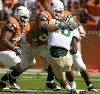 AUSTIN, TX - NOVEMBER 8:  Defensive tackle Roy Miller #99 of the Texas Longhorns sacks quarterback Robert Griffin #10 of the Baylor Bears in the second quarter on November 8, 2008 at Darrell K Royal-Texas Memorial Stadium in Austin, Texas.  (Photo by Bria