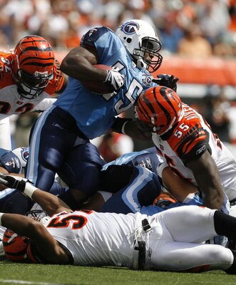 CINCINNATI - SEPTEMBER 14:  Ahmard Hall #45 of the Tennessee Titans is hit by Keith Rivers #55 of the Cincinnati Bengals during the first quarter of their NFL game September 14, 2008 at Paul Brown Stadium in Cincinnati, Ohio. The Titans defeated the Benga