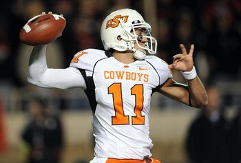 LUBBOCK, TX - NOVEMBER 08:  Quarterback Zac Robinson #11 of the Oklahoma State Cowboys drops back to pass against the Texas Tech Red Raiders at Jones AT&T Stadium on November 8, 2008 in Lubbock, Texas.  (Photo by Ronald Martinez/Getty Images)