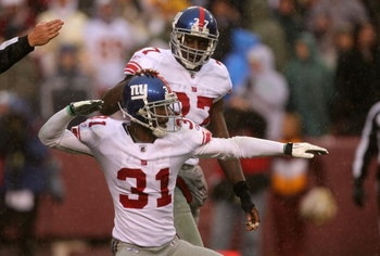LANDOVER, MD - NOVEMBER 30:  Aaron Ross #31 of the New York Giants celebrates after an interception with teammate James Butler #37 against the Washington Redskins during their game at FedEx Field on November 30, 2008 in Landover, Maryland.  (Photo by Stre