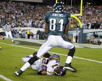 PHILADELPHIA - SEPTEMBER 20:  Terrell Owens #81 of the Philadelphia Eagles runs over Antoine Winfield #26 of the Minnesota Vikings in route to a touchdown at Lincoln Financial Field on September 20, 2004 in Philadelphia, Pennsylvania. (Photo by Ezra Shaw/
