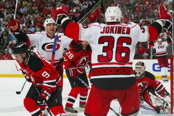 NEWARK, NJ - APRIL 28:  Jussi Jokinen #36 of the Carolina Hurricanes celebrates with teammate Rod Brind'Amour #17 of the New Jersey Devils after Joikinen scored the tying goal at 18:40 in the third period during Game Seven of the Eastern Conference Quarte
