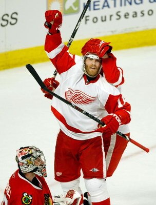 CHICAGO - MAY 22:  Dan Cleary #11 of the Detroit Red Wings celebrates with Brad Stuart #23 (obscured) after Brian Rafalski #28 scored a goal in the second period against goalie Nikolai Khabibulin #39 (L) the Chicago Blackhawks during Game Three of the Wes