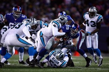 EAST RUTHERFORD, NJ - DECEMBER 21:  Full Back Madison Hedgecock #39 of the New York Giants gets tackled by Damione Lewis #92 of the Carolina Panthers on December 21, 2008 at Giants Stadium in East Rutherford, New Jersey.  (Photo by Chris McGrath/Getty Ima