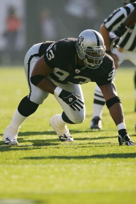 OAKLAND - DECEMBER 19:  Tommy Kelly #93 of the Oakland Raiders gets into position before the snap during the game against the Tennessee Titans on December 19, 2004 at Network Associates Colesium in Oakland, California.  (Photo by Lisa Blumenfeld/Getty Ima