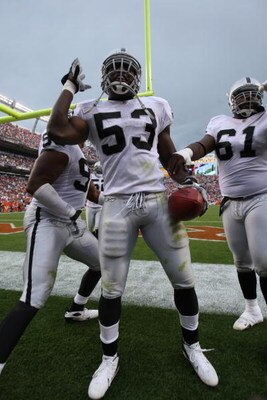 DENVER - SEPTEMBER 16:  Thomas Howard #53 of the Oakland Raiders celebrates his interception for a touchdown against the Denver Broncos as the Broncos defeated the Raiders 23-20 in overtime during week two NFL action at Invesco Field at Mile High on Septe