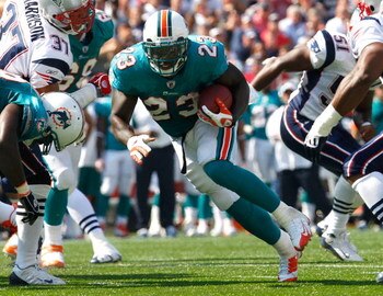 FOXBORO, MA - SEPTEMBER 21: Ronnie Brown #23 of the Miami Dolphins runs for a touchdown against the New England Patriots at Gillette Stadium on September 21, 2008 in Foxboro, Massachusetts. The Dolphins won 38-13. (Photo by Jim Rogash/Getty Images)