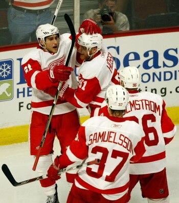 CHICAGO - MAY 24:  Valtteri Filppula #51 of the Detroit Red Wings celebrates with Marian Hossa #81, Tomas Holmstrom #96 and Mikael Samuelsson #37 after Filppula scored a goal in the second period against the Chicago Blackhawks during Game Four of the West