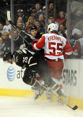 DALLAS - JANUARY 12:  Left wing Jere Lehtinen #26 of the Dallas Stars places a hip check on Niklas Kronwall #55 of the Detroit Red Wings in the first period at the American Airlines Center on January 12, 2009 in Dallas, Texas.  (Photo by Ronald Martinez/G