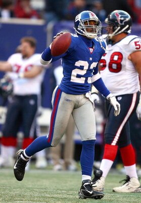 EAST RUTHERFORD, NJ - NOVEMBER 05:  Corey Webster #23 of the New York Giants recovers a fumble in the fourth Quarter against the Houston Texans on November 5, 2006 at Giants Stadium in East Rutherford, New Jersey. The Giants defeated the Texans 14-10.  (P