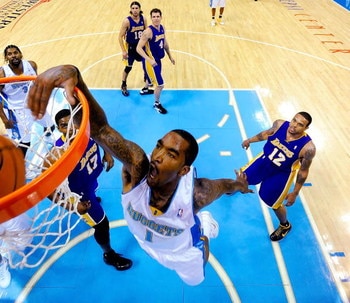 DENVER - MAY 25:  J.R. Smith #1 of the Denver Nuggets dunks the ball over Andrew Bynum #17 of the Los Angeles Lakers in Game Four of the Western Conference Finals during the 2009 NBA Playoffs at Pepsi Center on May 25, 2009 in Denver, Colorado. NOTE TO US