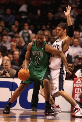 EAST RUTHERFORD, NJ - MARCH 04:  Brook Lopez  #11 of the New Jersey Nets guards Leon Powe  #0 of Boston Celtics during their game on March 4th, 2009 at The Izod Center in East Rutherford, New Jersey.  NOTE TO USER: User expressly acknowledges and agrees t