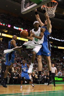 BOSTON - MAY 17:  Rajon Rondo #9 of the Boston Celtics passes the ball as Marcin Gortat #13 of the Orlando Magic defends Game Seven of the Eastern Conference Semifinals during the 2009 NBA Playoffs at TD Banknorth Garden on May 17, 2009 in Boston, Massach