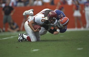 12 Sep 1998: Andres Vige #10 the N.E Louiisana is tackled by Reggie McGrew #92 of the Florida Gators at Folrida Field in Gainsville, Florida. Florida Gators defeated N,E Louisiana