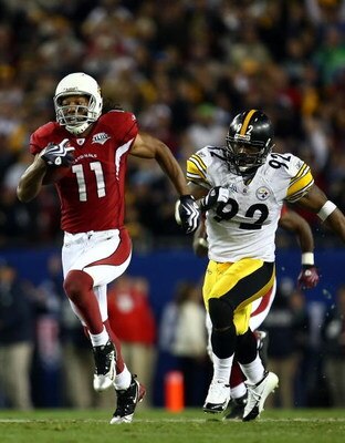 TAMPA, FL - FEBRUARY 01:  Larry Fitzgerald #11 of the Arizona Cardinals runs for a touchdown after a catch against James Harrison #92 of the Pittsburgh Steelers in the fourth quarter during Super Bowl XLIII on February 1, 2009 at Raymond James Stadium in 