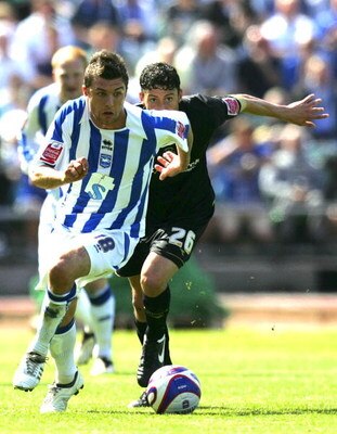 BRIGHTON, UNITED KINGDOM - MAY 02: Doug Loft of Brighton & Hove Albion and Matty Mainwaring of Stockport County run to the ball during the Coca Cola League One match between Brighton & Hove Albion and Stockport County at Withdean Stadium on May 02, 2009 i