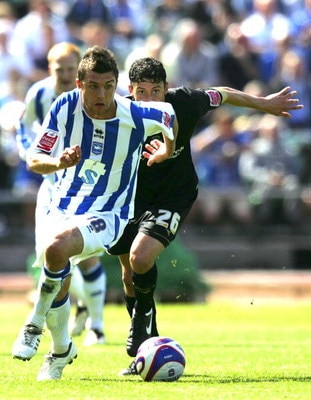 BRIGHTON, UNITED KINGDOM - MAY 02: Doug Loft of Brighton & Hove Albion and Matty Mainwaring of Stockport County run to the ball during the Coca Cola League One match between Brighton & Hove Albion and Stockport County at Withdean Stadium on May 02, 2009 i