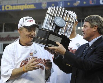 TAMPA, FL - DECEMBER 6: Coach Frank Beamer of the Virginia Tech Hokies takes the winner's trophy from ACC commissioner John Swofford after play against the Boston College Eagles in the 2008 ACC Football Championship game at Raymond James Stadium on Decemb