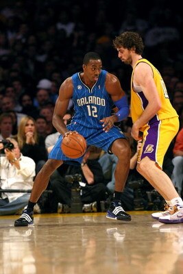 LOS ANGELES - JANUARY 16:  Dwight Howard #12 of the Orlando Magic dribbles the ball to the basket against Pau Gasol #16 of the Los Angeles Lakers during their NBA game on January 16, 2009 at Staples Center in Los Angeles, California. The Magic won 109-103