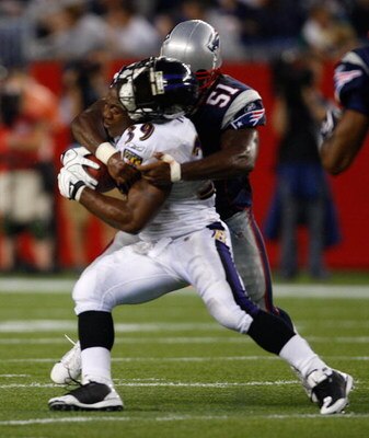 FOXBORO, MA - AUGUST 7: Ray Rice #39 of the Baltimore Ravens has his helmet knocked off as he is tackled by Jerod Mayo #51 of the New England Patriots during the preseason game at Gillette Stadium on August 7, 2008 in Foxboro, Massachusetts. (Photo by Jim