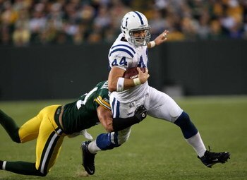 GREEN BAY, WI - OCTOBER 19:  Tight end Dallas Clark #44 of the Indianapolis Colts carries the ball as he is tackled by linebacker Brandon Chillar #54 of the Green Bay Packers on October 19, 2008 at Lambeau Field in Green Bay Wisconsin. The Packers won 34-