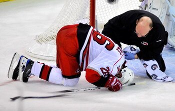 PITTSBURGH - MAY 18:  Erik Cole #26 of the Carolina Hurricanes is tended to by the trainer after a collision against the Pittsburgh Penguins during Game One of the Eastern Conference Championship Round of the 2009 Stanley Cup Playoffs on May 18, 2009 at M
