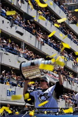PITTSBURGH - JUNE 15:  Marc-Andre Fleury #29 of the Pittsburgh Penguins holds aloft the Stanley Cup for the crowd on the Blvd of the Allies during Stanley Cup Champion Victory Parade on June 15, 2009 in Pittsburgh, Pennsylvania.  (Photo by Jamie Sabau/Get